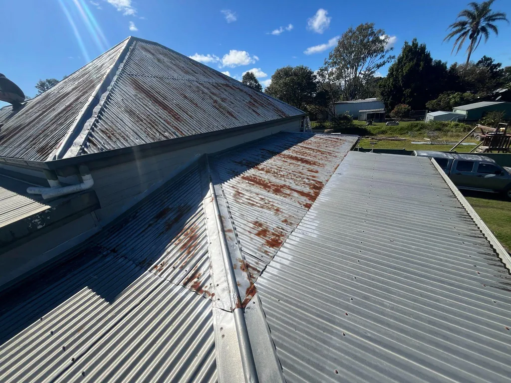 Before: rusted ridge and roof sheeting