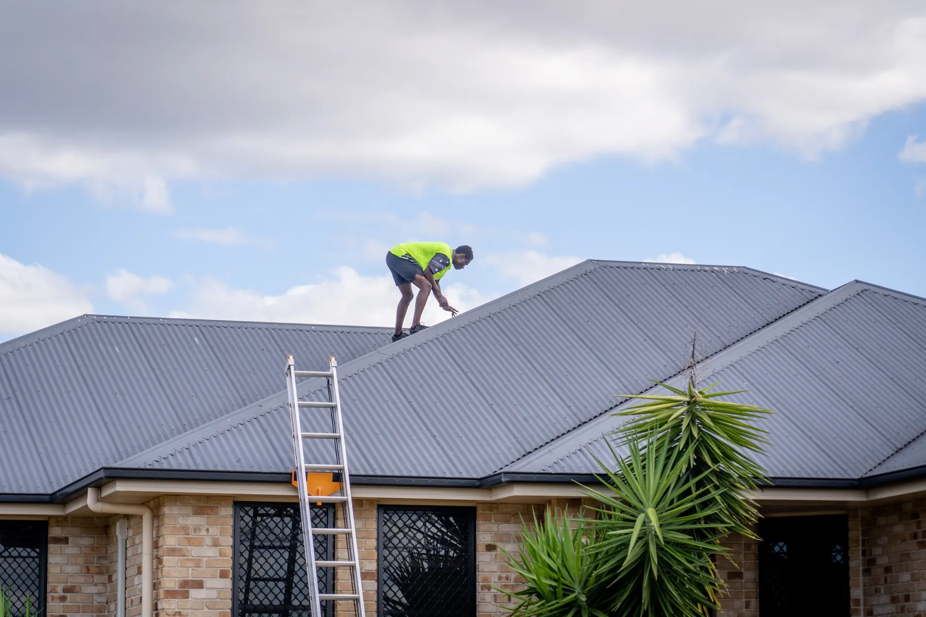 All Clear Inspect inspector checking a metal roof on a Queensland home